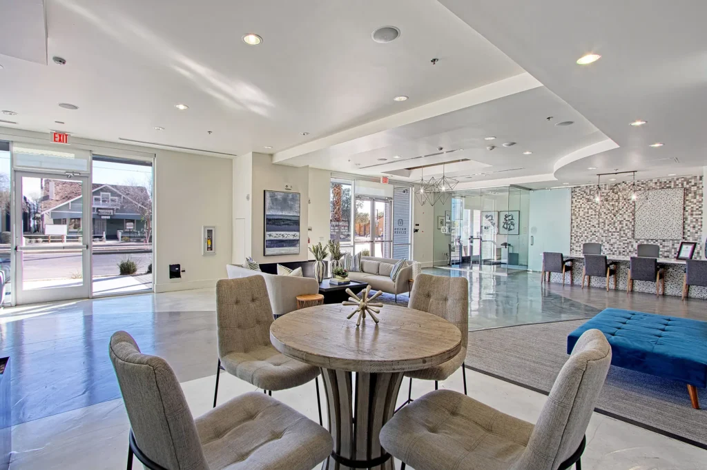 Modern clubhouse interior with seating and dining space.